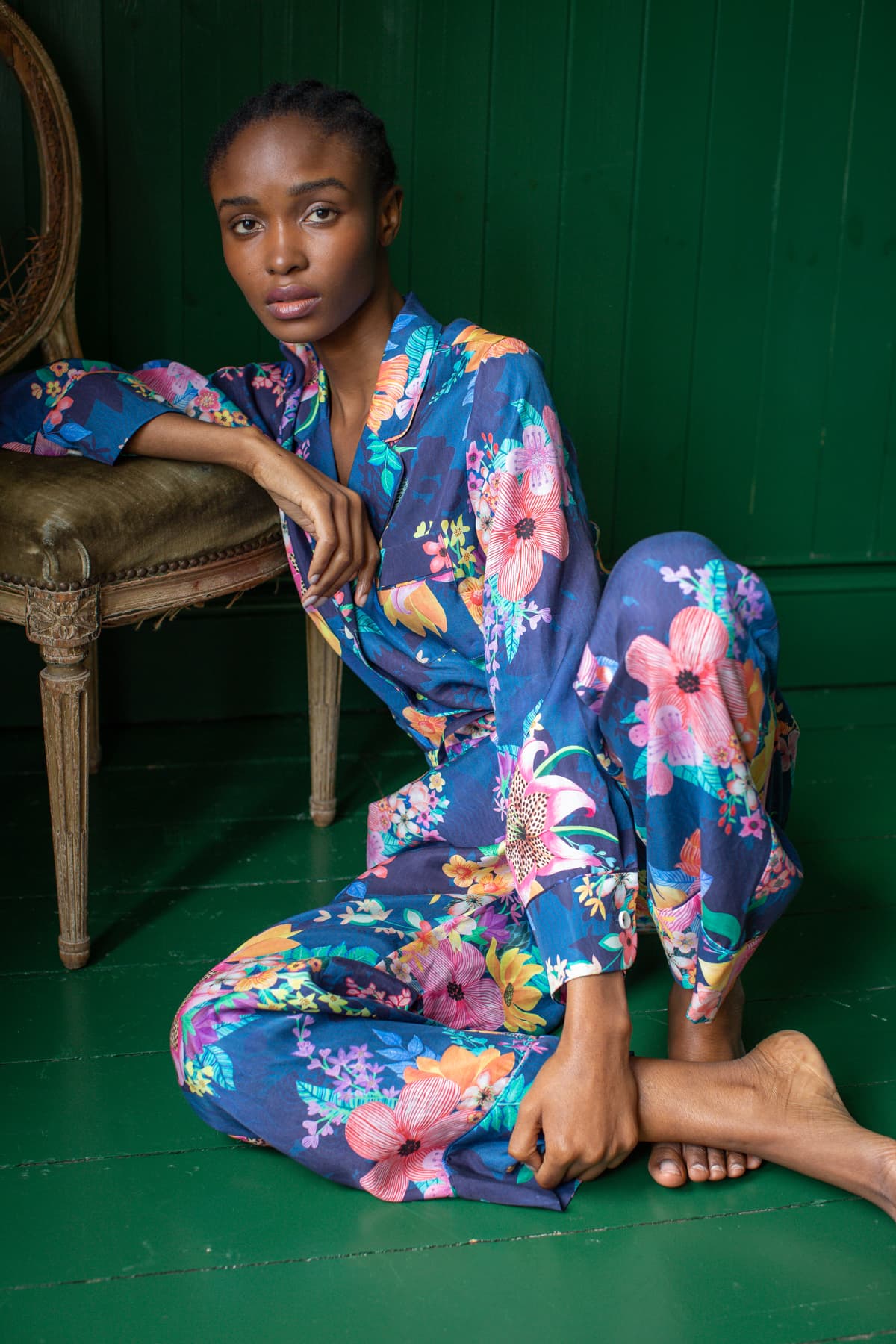 Calypso Luxury Pyjamas - Relaxing against chair - Orchard Moon - Sustainable Luxury Loungewear